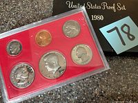 1980 United States Proof Set displayed in original protective plastic case on a red insert, showing all six coins.