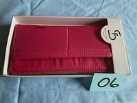 Top view of sealed pink wallet by Stella & Fritz in its original box with logo visible.
