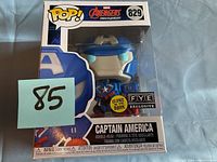 Front view of boxed Captain America bobble-head figure labeled PYE exclusive with glow in the dark feature.