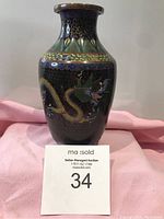 Front and side view of 19th century cloisonné vase showing dragon design on dark blue background with multicolor enamel patterns.