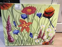 Full front view of the acrylic flower painting on a light green background showing multiple flower types and colours.