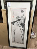 Full view of framed vertical Asian ink painting showing lotus flowers, leaves, bird, calligraphy, and red stamps.
