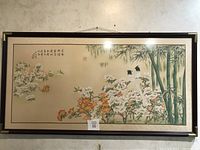 Full view of framed Asian painting with birds, bamboo, flowers, calligraphy, and seals