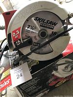 Close-up view of the Skilsaw circular hand saw blade and outer casing showing model and power specifications.