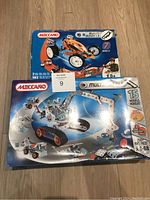 Two Meccano Multimodels kit boxes showing vehicle models on them