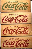 Four vintage wooden Buvez Coca-Cola signs from 1965. Three with red lettering and one with green lettering on natural wood boards.