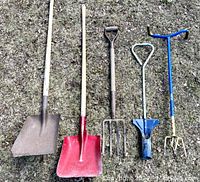 Photo showing all five gardening tools laid out on grass including two shovels, pitchfork, bulb planter, and garden claw cultivator.