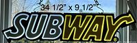 Photo showing a lighted Subway sign with the dimensions labeled 34 1/2" x 9 1/2"