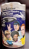 View-Master container with Star Trek artwork showing Spock, Captain Kirk, and others, with cylindrical shape and plastic wear at edges.