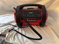 Front and top view showing the digital control panel, flexible hose, and carry handle.