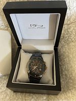 Daniel Steiger men's watch in black and rose gold, displayed inside original branded box with white interior lining.