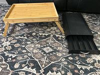Wooden bed tray and black Keurig pod holder side by side showing tray legs and pod holder structure