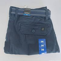 Folded navy blue men's cargo shorts with flap button pocket showing the Buffalo David Bitton logo patch and size 36 stickers.