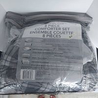 8 piece comforter set packed and sealed in original plastic packaging with label showing contents and dimensions.