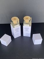 Two Puebco Omnibus fragrance diffusers with wooden stoppers and white caps, showing clear bottles with labels 'Omnibus Fragrance Scent Brisk No. 106413 MON'.