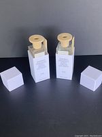 Two Puebco Omnibus fragrance diffuser bottles with wooden caps and white packaging boxes, displaying the product and scent details.