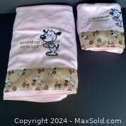Photo of the two hand towels and one bath towel stacked showing embroidered dog holding heart and LOVE FOREVER text, with decorative trim.