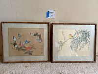 Pair of framed Chinese watercolor paintings featuring butterflies and a bird, both under glass in bamboo-style frames.