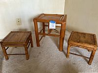 Three bamboo plant stands shown together on carpeted floor.