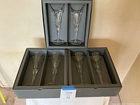 Six champagne flutes in three fitted presentation boxes, two per box.
