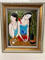 Full view of the oil painting showing two women in blue dresses, a red bird on one shoulder, oranges on a table, a bottle, and leaves in the background within a framed border.