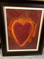 Framed watercolour painting showing a large red heart surrounded by orange and yellow glow effects, signed by artist Pedie Wolfond.