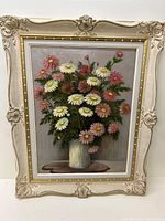 Full view of framed painting of pink and white daisies in vase, showing ornate carved frame and signature.