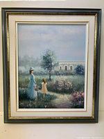 Framed full view of the painting showing the woman in blue and child in cream dress against a garden background with trees and stone bridge.