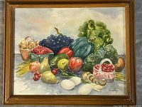 Full view of the framed watercolour still life painting depicting fruits and vegetables, signed by K. Long.