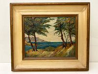 Framed oil on board landscape painting showing trees, water, and distant land in a wooden frame.
