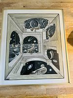 Full view of framed print laid on wooden floor