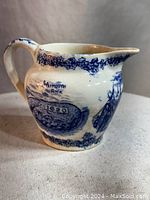 Front view showing Plymouth Rock image with 1620 date and blue floral border.