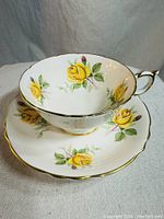 Photo showing the vintage Paragon cup with yellow rose design inside and on exterior, paired with matching saucer.