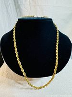 Full view of the gold tone rope chain necklace displayed on a black bust, showing the chain's overall length and rope design.