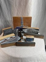 Photo showing multiple vintage wooden printing blocks featuring metal printing plates with text and images.