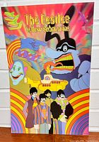 Front view of the vibrant Beatles Yellow Submarine 3D lenticular poster showing cartoon characters and The Beatles in psychedelic style with text.