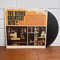 Front side of The Kinks Greatest Hits vinyl album cover with LP partially pulled out, displaying album artwork and title.