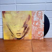 Front cover of the Goats Head Soup album by The Rolling Stones showing worn and faded cover art with LP partially visible inside.