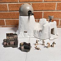 Overview of the Hoth micro playset showing igloo base, cannon, control panels, and figures arranged in front.