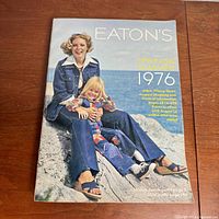 Full cover view of vintage 1976 Eatons Spring & Summer shopping catalog featuring two models in denim outfits sitting on rocks.