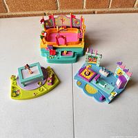 Overview of all three vintage Polly Pocket gymnastic toy sets showing bright colors and figurines