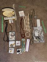 Overview of assorted jewelry laid out on carpet