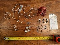 All items arranged on wooden surface with measuring tape.