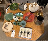 Overview of all items showing variety of ceramic pots, plates, coloured glass pieces and barware including oil lamp