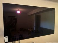 Front view of TV mounted on wall showing display and frame