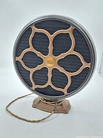 Front view of antique circular Atwater Kent speaker showing decorative grille and mesh.