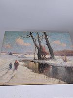 Full view of the antique Dutch oil painting on panel featuring a snowy winter landscape with two figures walking, trees, water reflections, and distant buildings under a partly cloudy sky.