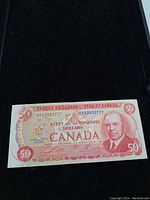 Obverse side of the 1975 Canadian $50 banknote depicting William Lyon Mackenzie King and the Canadian coat of arms.