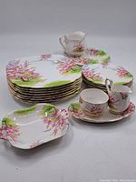 Group view of plates, platters, creamer, sugar bowl, cup, saucer and tray