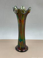 Full view of the vase showing its overall shape, lustre finish, and vertical textured pattern.